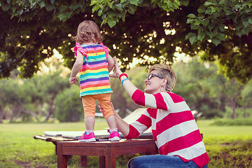 Image showing mom and her little daughter using tablet computer