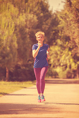 Image showing young female runner training for marathon