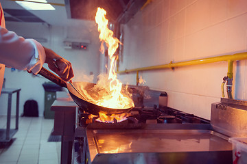 Image showing Chef doing flambe on food