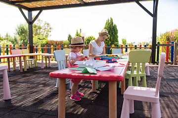 Image showing mom and little daughter drawing a colorful pictures