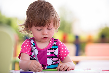 Image showing little girl drawing a colorful pictures