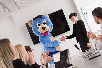 Image showing boss dresed as bear having fun with business people in trendy of