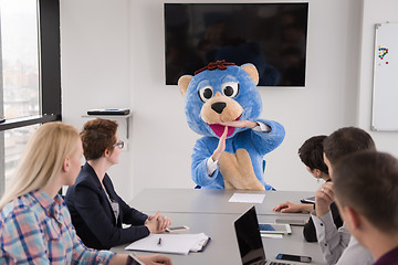 Image showing boss dresed as bear having fun with business people in trendy of