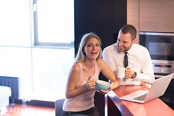 Image showing A young couple is preparing for a job and using a laptop