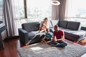 Image showing Happy family playing a video game