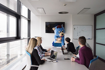 Image showing boss dresed as bear having fun with business people in trendy of