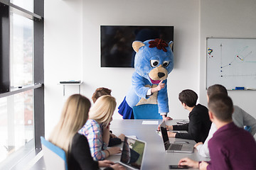 Image showing boss dresed as bear having fun with business people in trendy of