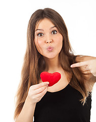 Image showing young woman in love with a heart in hand