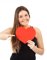 Image showing young woman in love with a heart in hand