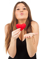 Image showing young woman in love with a heart in hand