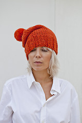 Image showing Pretty young woman in warm orange beanie.