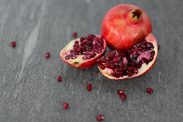 Image showing close up of pomegranate on stone table