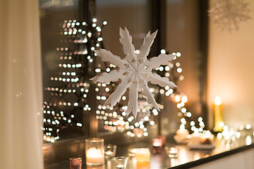 Image showing paper snowflake decoration hanging on window