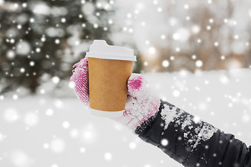 Image showing close up of hand with coffee outdoors in winter