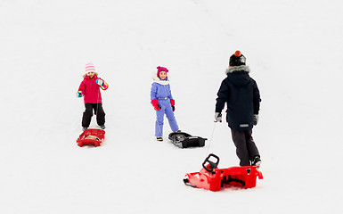 Image showing happy little kids with sleds in winter