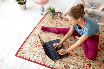 Image showing woman with laptop computer at yoga studio