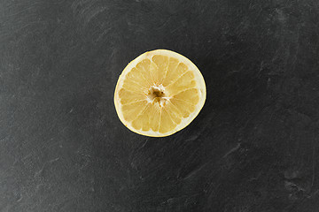 Image showing close up of lemon slice on slate table top