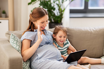 Image showing pregnant mother and daughter having video chat