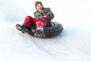 Image showing Happy boy with snow tube