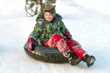 Image showing Happy boy with snow tube