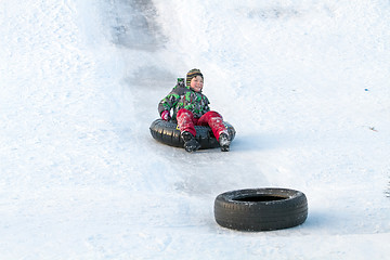 Image showing Happy boy with snow tube