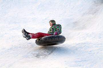 Image showing Happy boy with snow tube