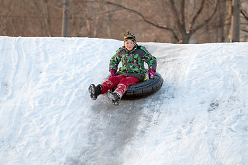 Image showing Happy boy with snow tube