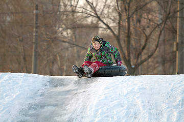 Image showing Happy boy with snow tube