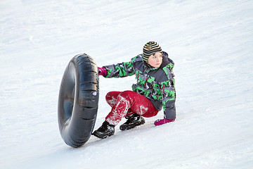 Image showing Happy boy with snow tube