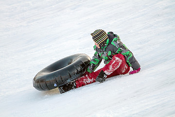 Image showing Happy boy with snow tube