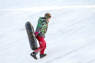 Image showing Happy boy with snow tube