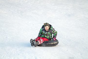 Image showing Happy boy with snow tube