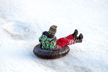 Image showing Happy boy with snow tube