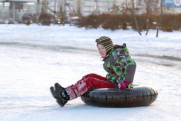 Image showing Happy boy with snow tube