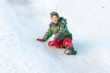 Image showing Happy boy with snow tube