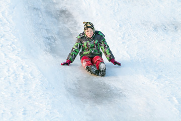 Image showing Happy boy with snow tube