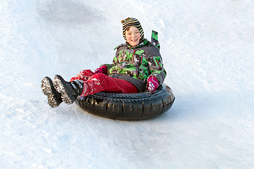 Image showing Happy boy with snow tube