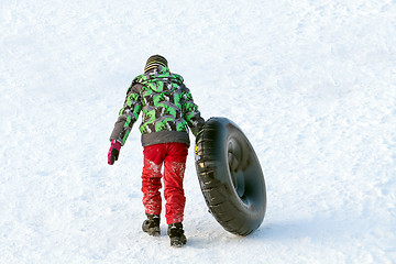 Image showing Happy boy with snow tube