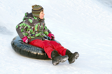 Image showing Happy boy with snow tube