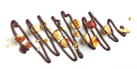 Image showing hazelnuts and chocolate sauce