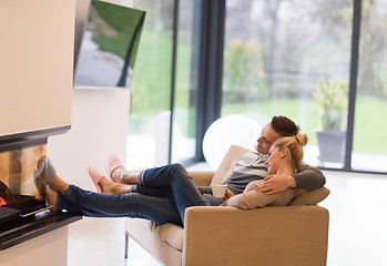 Image showing Young couple  in front of fireplace