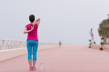 Image showing woman stretching and warming up on the promenade