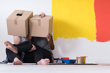 Image showing young multiethnic couple playing with cardboard boxes