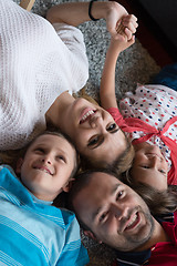 Image showing happy family lying on the floor