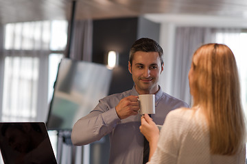 Image showing A young couple is preparing for a job and using a laptop