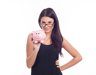 Image showing Young woman with glasses happy with piggy bank