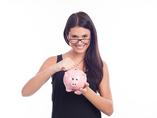 Image showing Young woman with glasses happy with piggy bank