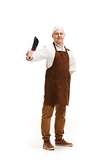 Image showing Smiling butcher posing with a cleaver isolated on white background