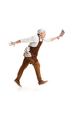 Image showing Smiling butcher posing with a cleaver isolated on white background