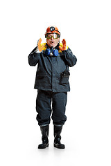 Image showing The studio shot of senior bearded male miner standing at the camera on a white background.